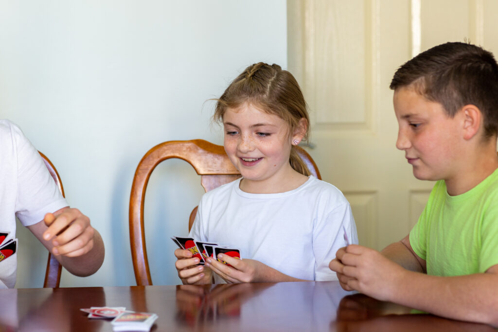 girl and boy playing card game 