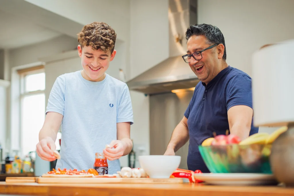 Man and teenage boy in kitchen