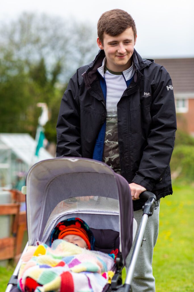 Man pushing a baby in a pram